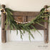 6ft Cedar Garland beautifully draped across a mantel, showcasing its realistic lifelike greenery, perfect for holiday decor.
