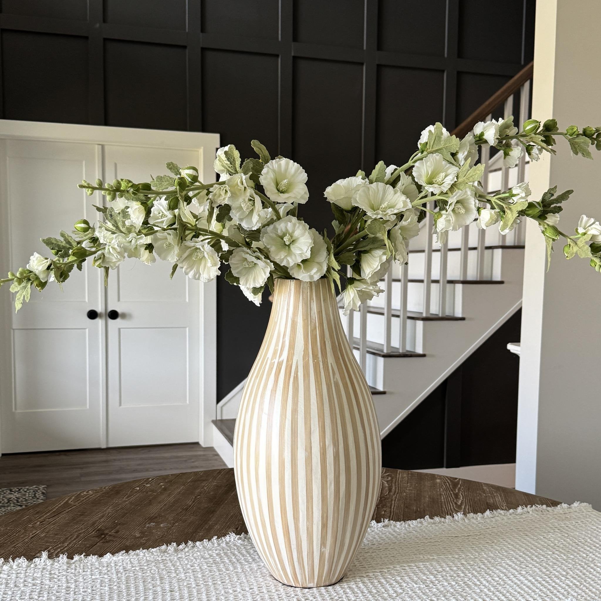 Overall view of the Hollyhock & Large Striped Vase Arrangement, displaying its dimensions of approximately 33 inches tall by 33 inches wide, perfect for home decor.