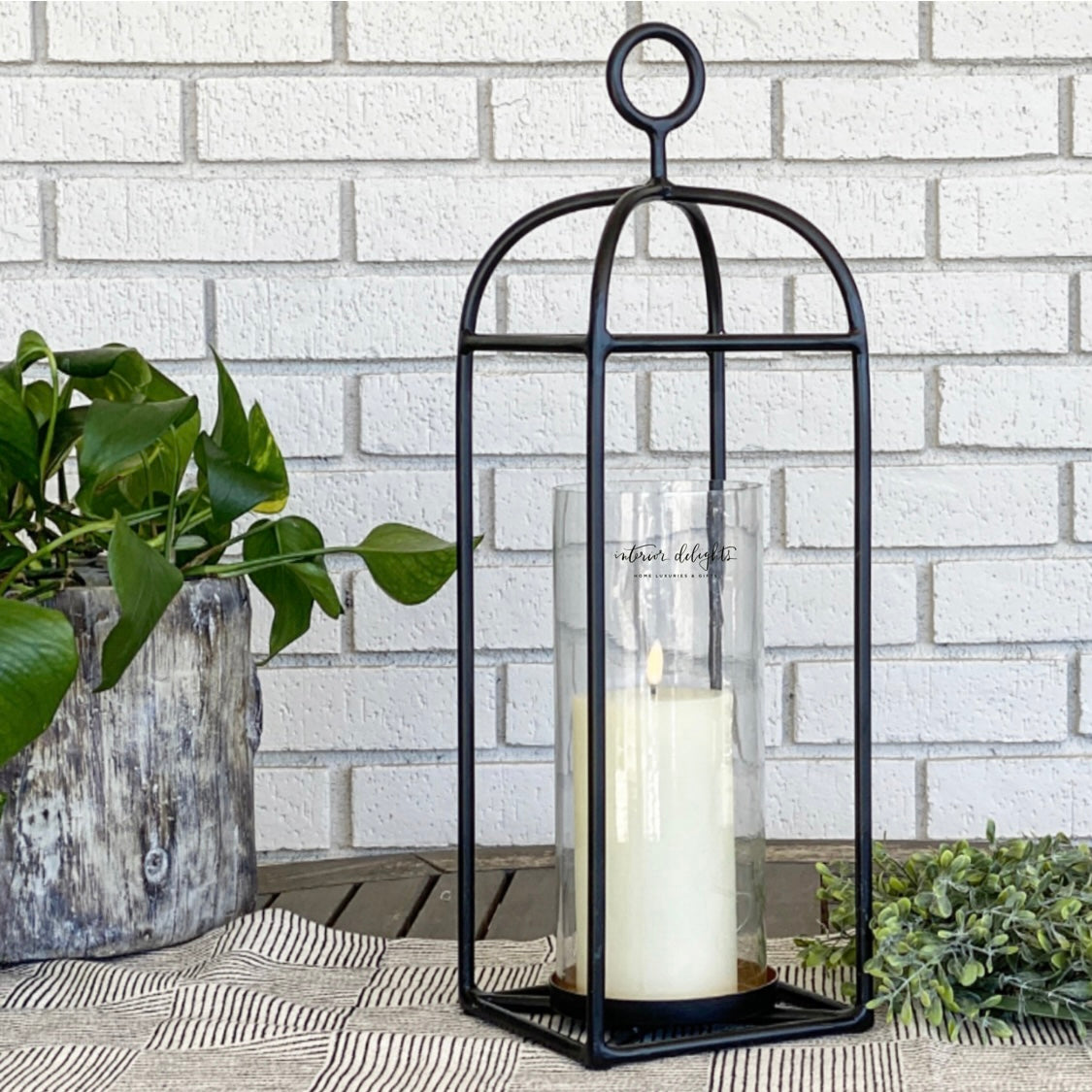 Black Rectangular Outdoor Lantern in 19-inch size on a porch with a flameless candle.