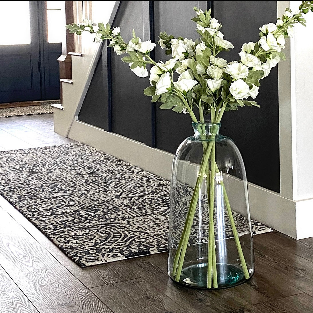 43" White Hollyhock Stem showcasing lifelike blooms and flexible stems, perfect for adding elegance and height to floral arrangements.