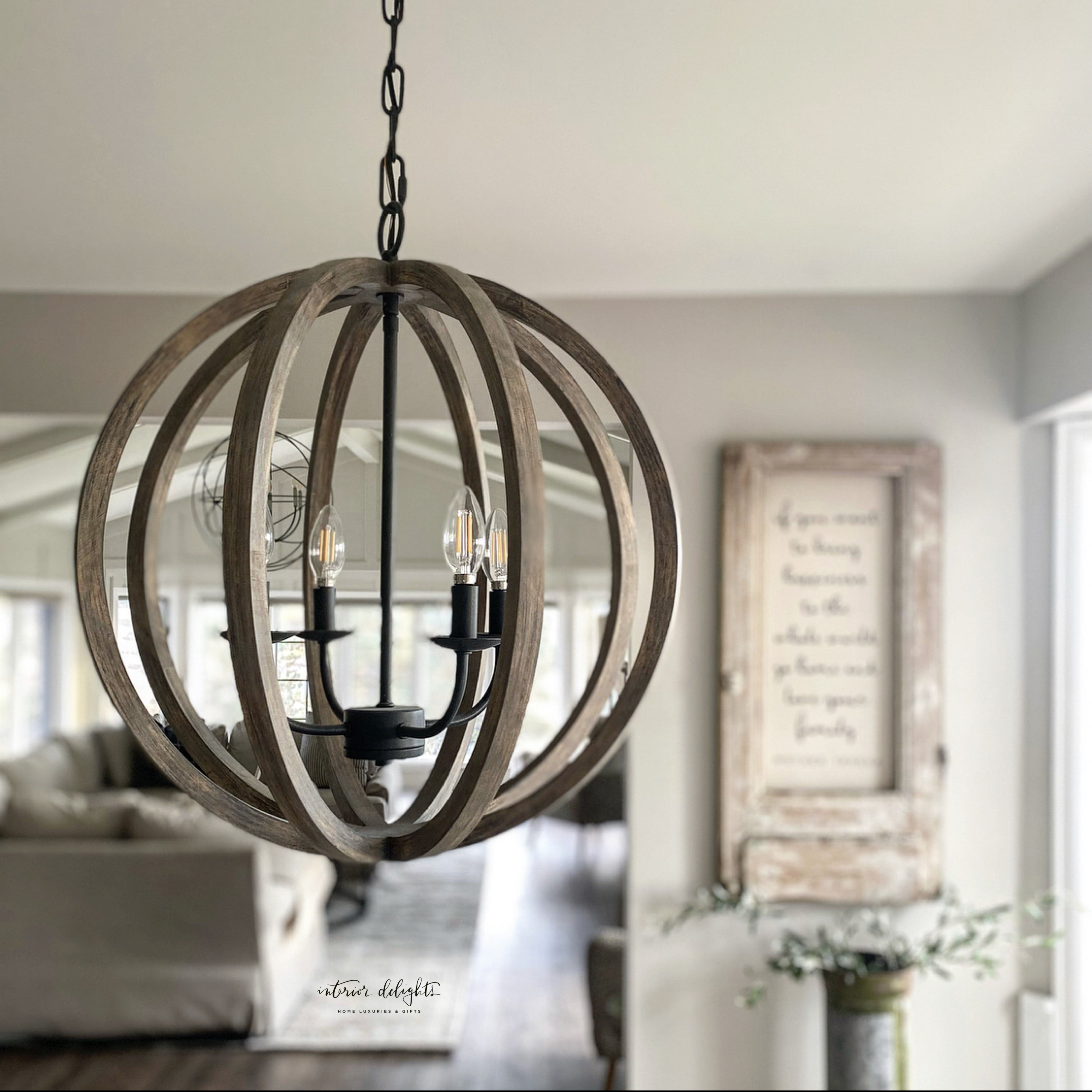 Allister 5 Light Chandelier hanging elegantly above a round kitchen table, showcasing its beautiful design and dimensions of 26" width and 28.63" height.