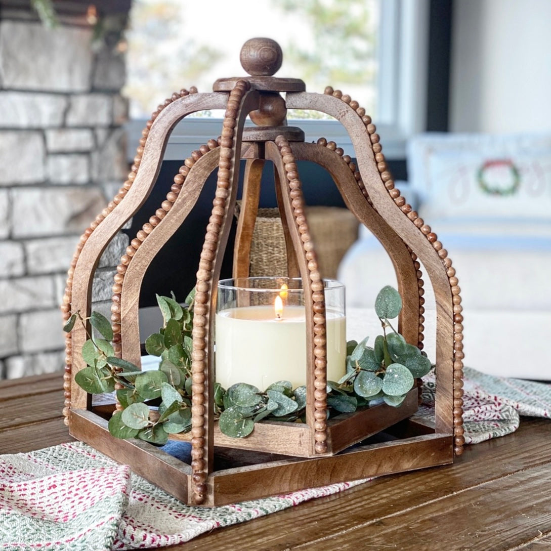 5.75” x 5.75” Ivory Flameless Candle displayed next to a standard candle for size comparison.