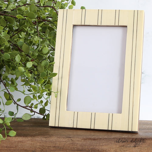 Ivory Striped Photo Frame showcasing a modern design with sleek lines and metal inlay, perfect for displaying cherished memories.