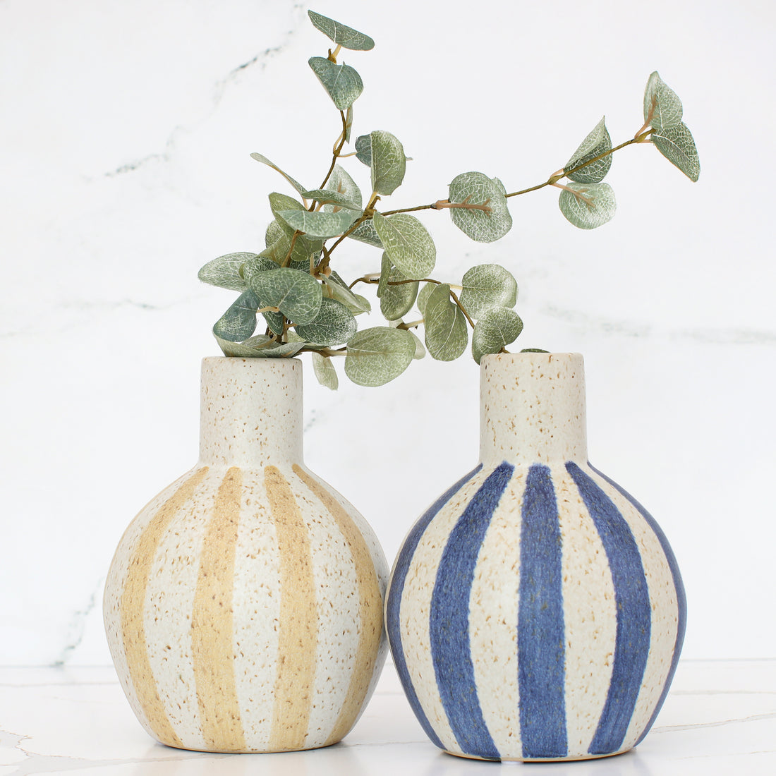 Stylish display of the 7" Matte Straw Stripe Ceramic Vase on a windowsill, enhancing the cozy ambiance with its unique design.