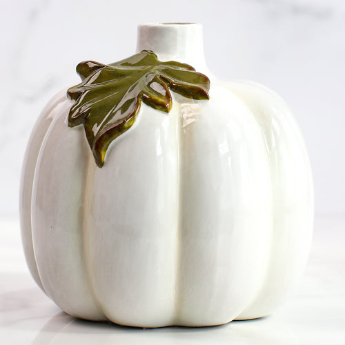 Large ceramic pumpkin bud vase with a glossy white glaze and green leaf accent, a stylish addition to any mantel or table.