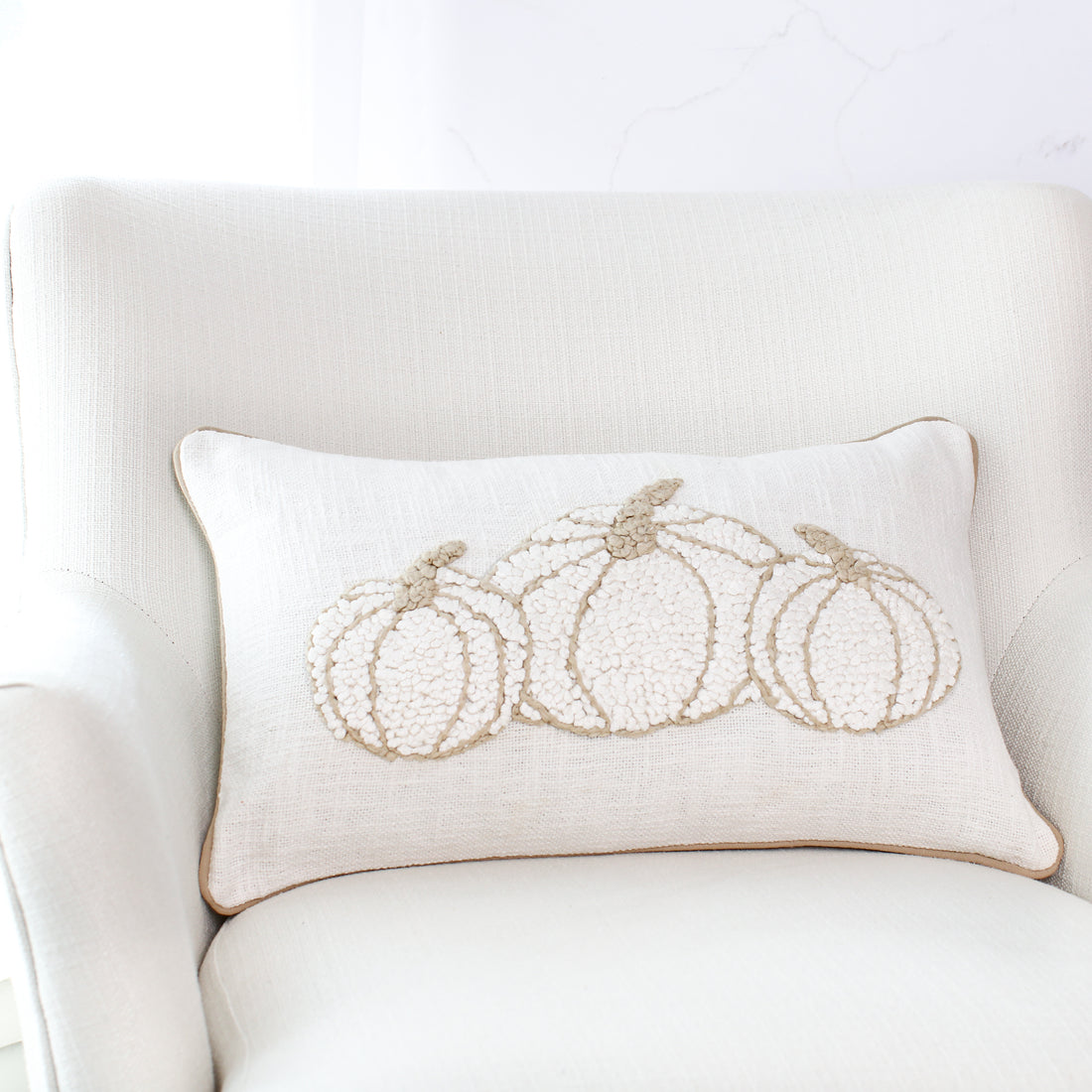 Triple Pumpkin Pillow featuring a woven off-white background with soft beige embroidery and matching trim, perfect for fall decor.