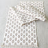 Taupe Block Print Table Runner displayed on a dining table with a soft fringe detail and intricate hand-stamped floral pattern.