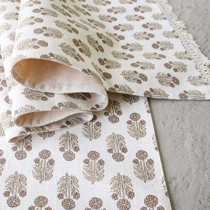 Taupe Block Print Table Runner with delicate hand-stamped floral design, showcasing its soft fringe detail.