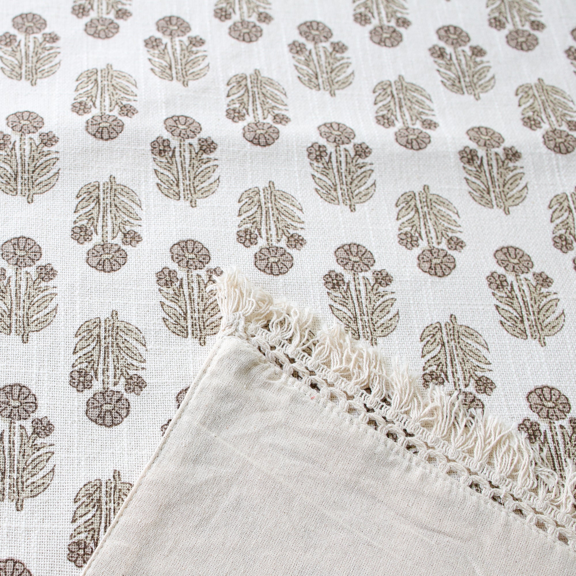 Close-up view of the Taupe Block Print Table Runner showcasing the delicate crochet fringe edges and cotton texture.