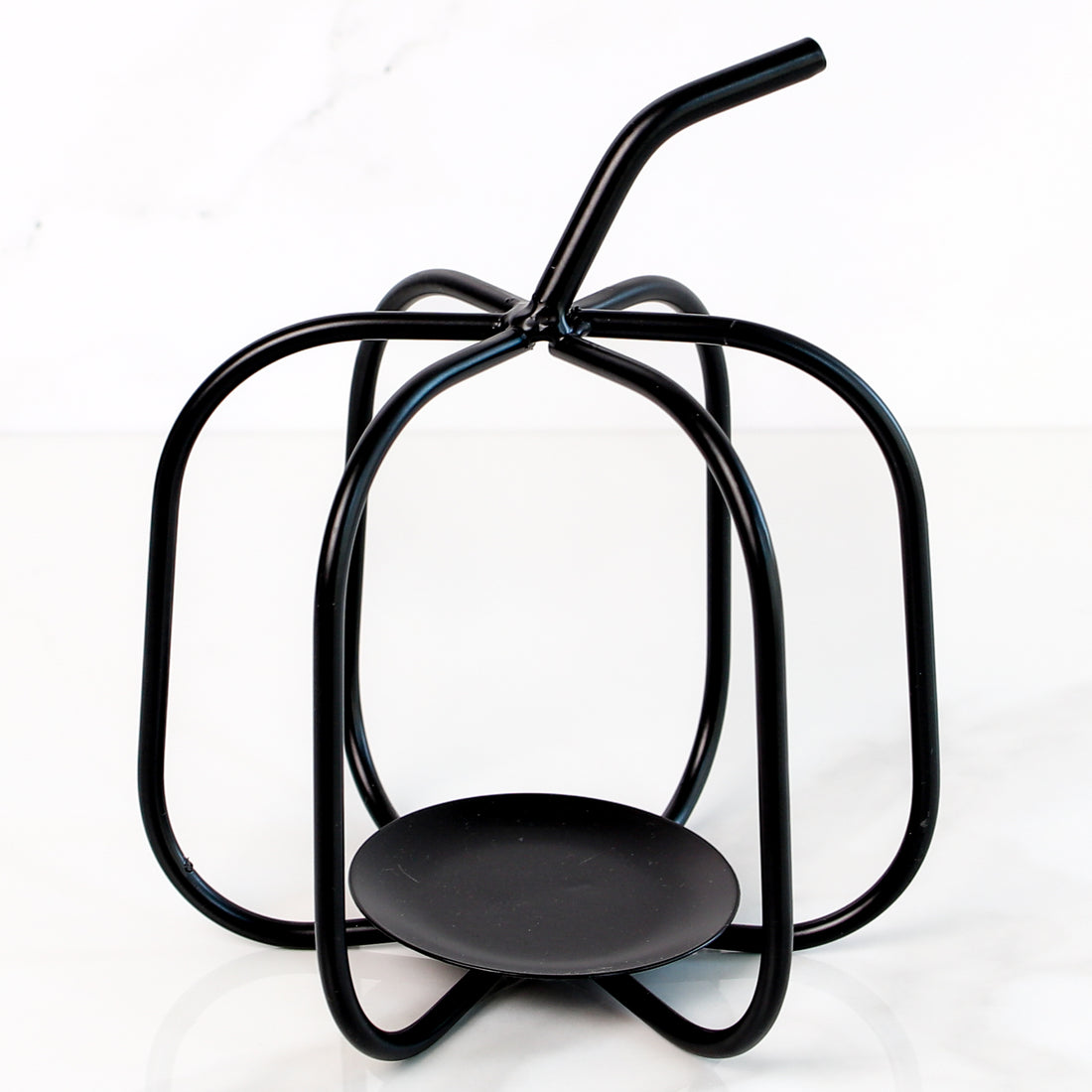 Handcrafted black metal pumpkin candle holder, featuring a rustic design perfect for autumn decor.