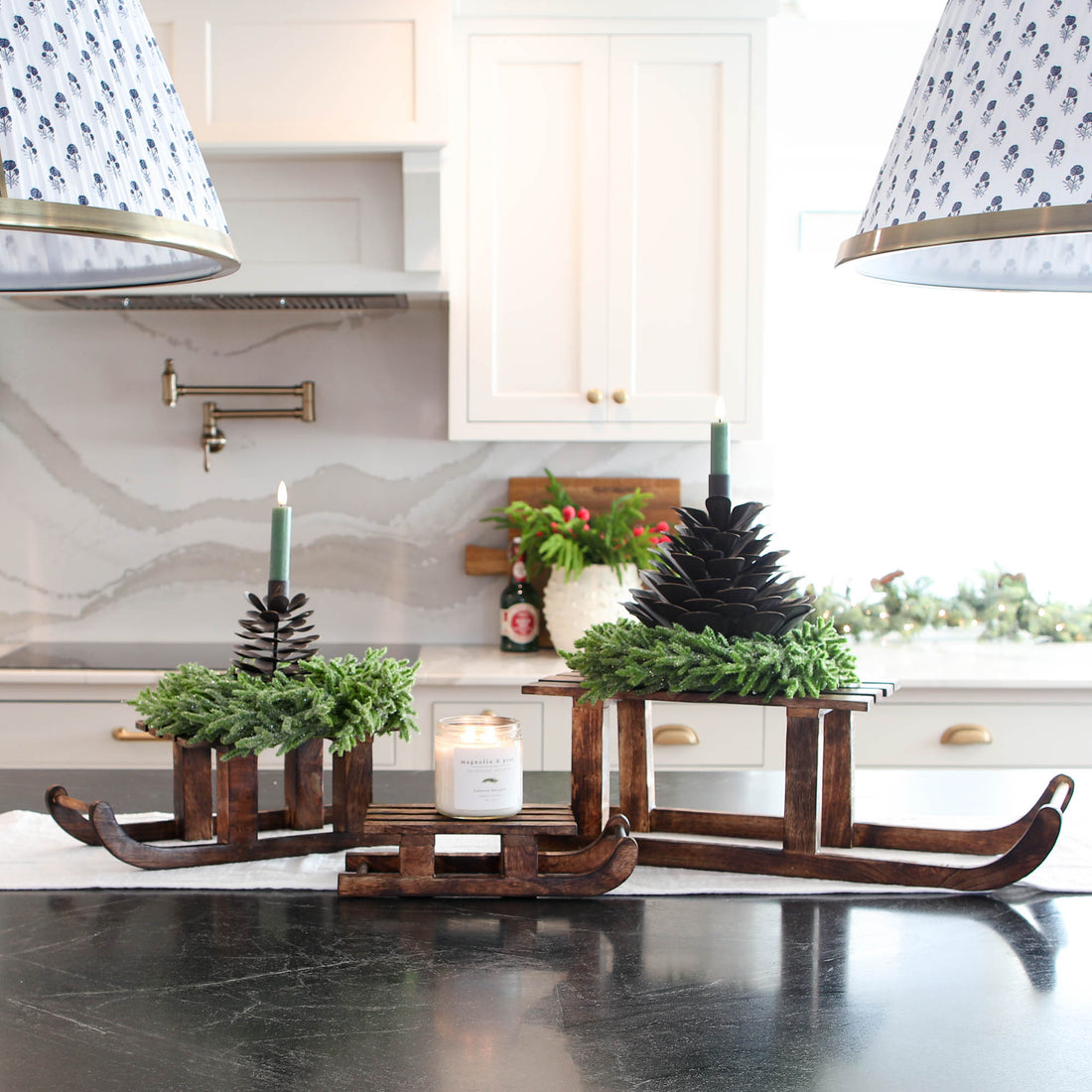 ARRANGEMENT: Sled Risers with Pinecones and Glitter Wreaths