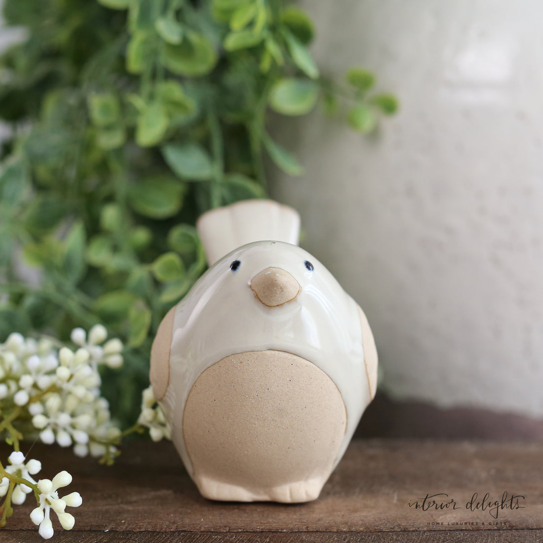 Bird Pot Perch decoration featured on a decorative vase, brightening up the indoor space.