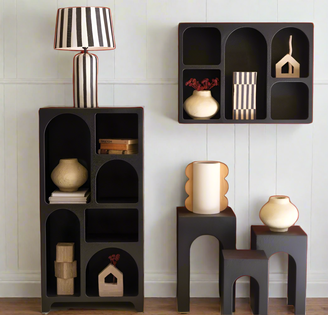 Black modular shelving units with decorative items on a white background