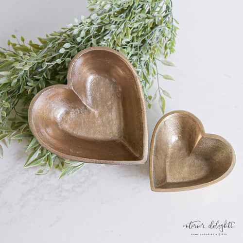 Brass Heart Bowls - Set of 2 displayed elegantly on a coffee table.