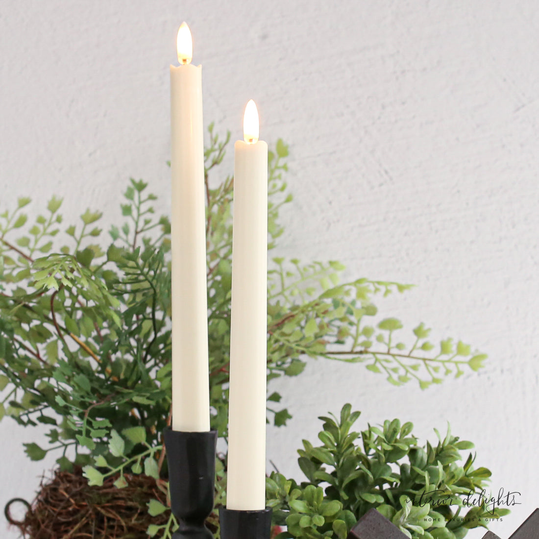 Flameless Taper Candles: Set of 2, realistic 10-inch tall plastic candles with a rubber base for stability in holders, ideal for cozy lighting without the mess of wax.