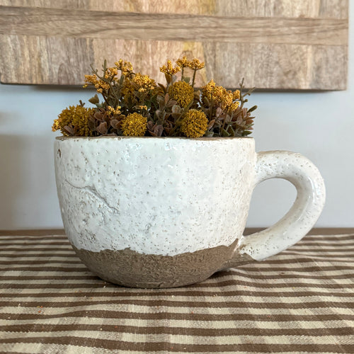 Oversized Mug: Planter showcasing a whimsical design perfect for seasonal plants and fall decor