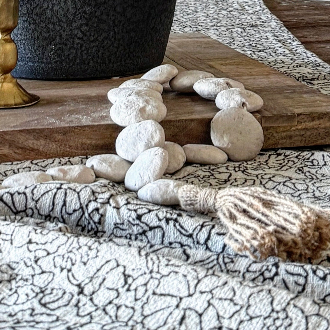 Charming Natural Textured Flat Bead Garland - 35in draped over a decorative tray showcasing its organic shape and neutral tones.
