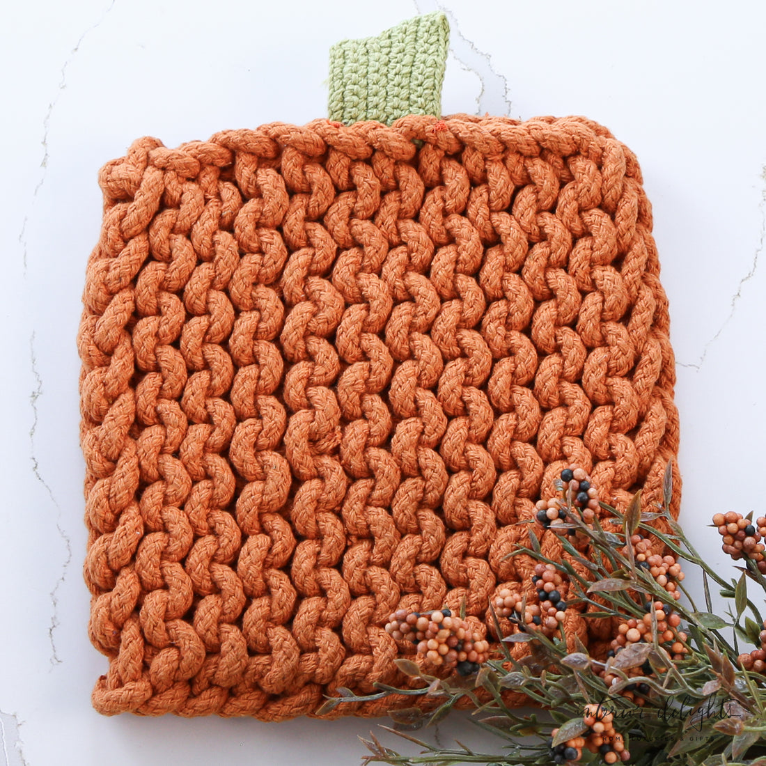 Stylish Pumpkin Knit Pot Holders in two styles, adding a seasonal touch to your kitchen decor.