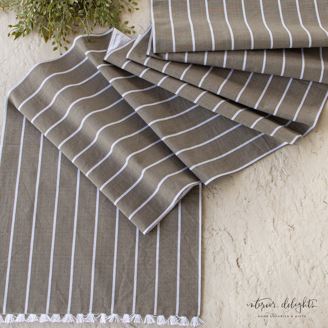 Close-up view of the Striped Table Runner with Fringe, highlighting the subtle pattern and texture in natural light.