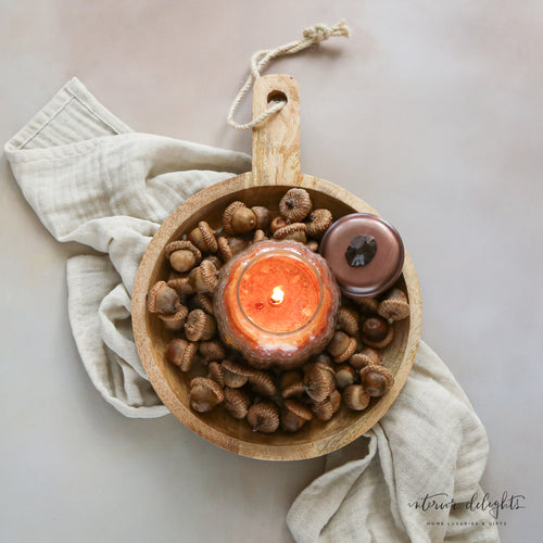 Carved mango wood bowl with handle beautifully showcasing its unique wood grain and rustic charm.