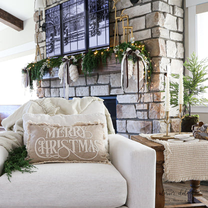 Stylish Beige Merry Christmas Pillow 12x20 displayed on a couch to enhance holiday décor.