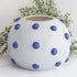 10” Luxe Round Ceramic Vase with Blue Knobs featuring a sculptural shape and soft white finish for elegant home decor.