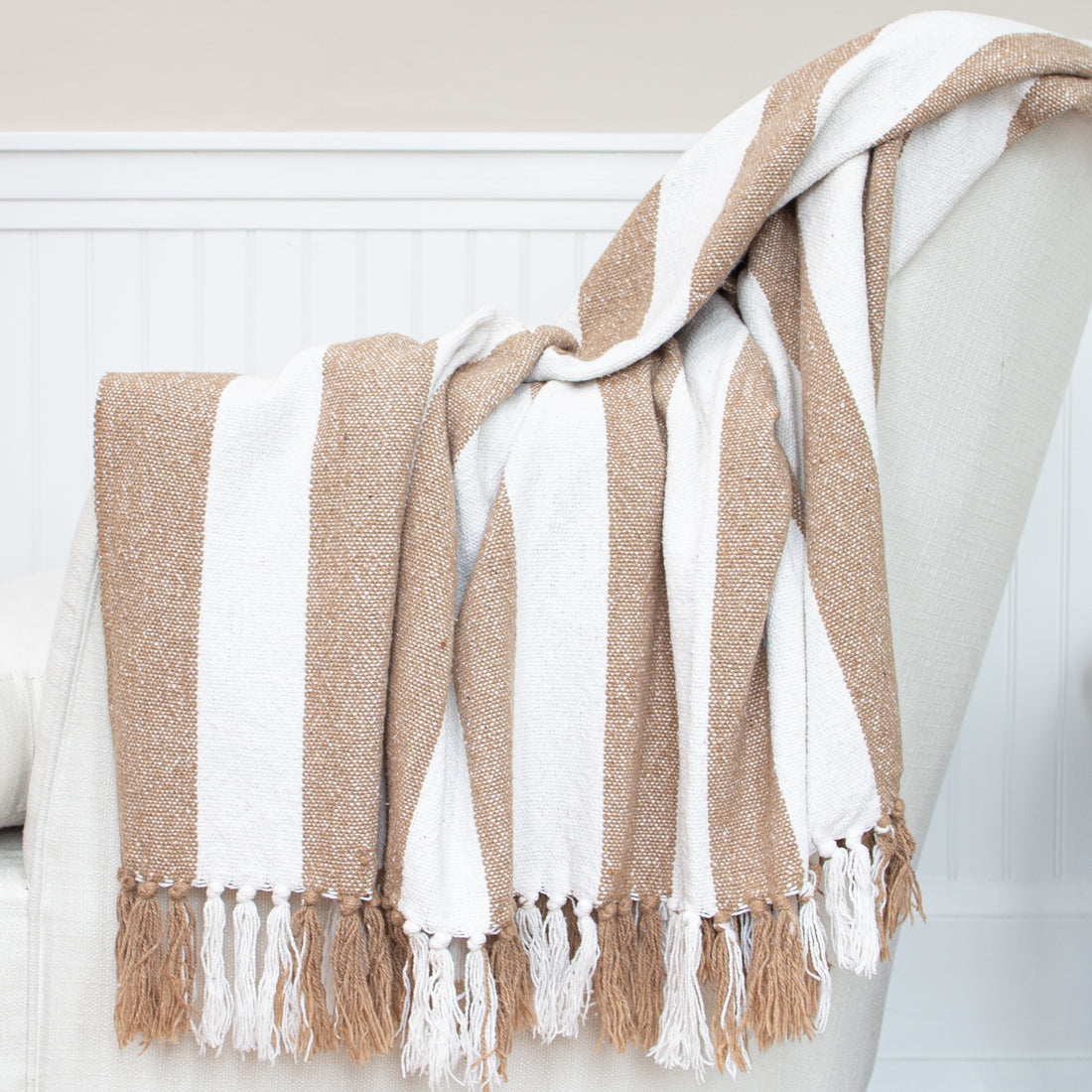 Striped Throws in natural with white stripe, featuring cozy texture and knotted tassel fringe.