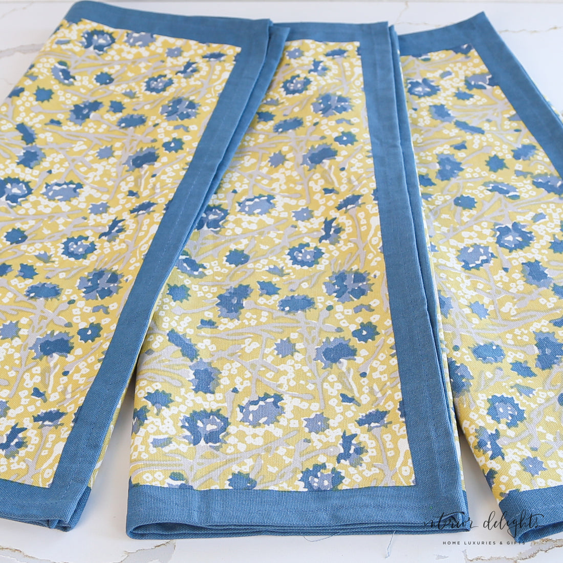 Meadows Blue and Gold Floral Tea Towels - Set of 3 featuring elegant floral designs, ideal for enhancing kitchen decor.
