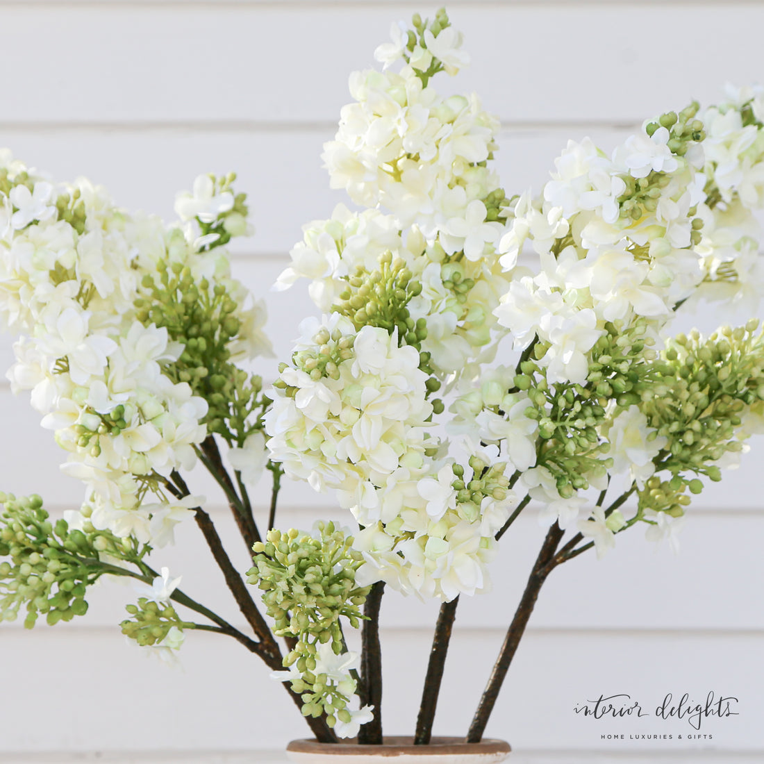 White Lilac Spray on a textured background, emphasizing its maintenance-free quality and elegance.
