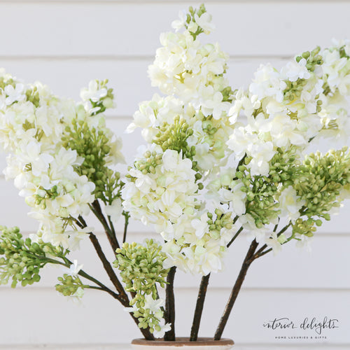 White Lilac Spray on a textured background, emphasizing its maintenance-free quality and elegance.