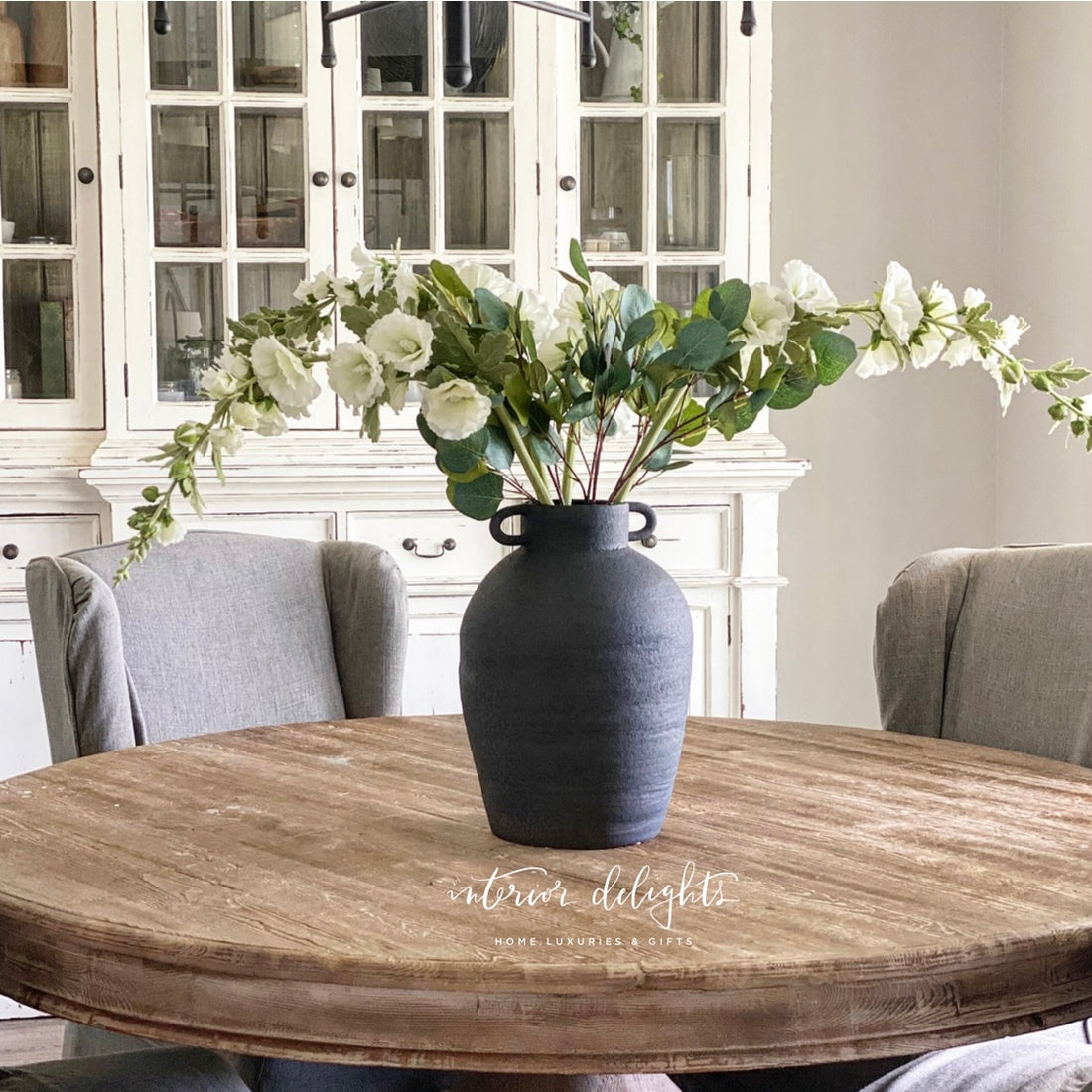 20" Ceramic Black Urn beautifully showcasing its rich, moody finish, perfect for displaying long stems in any season.