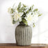 The 13-inch Arabesque Blooms Bundle displayed in a Grey Terracotta Ridge vase, adding charm and elegance to any setting.