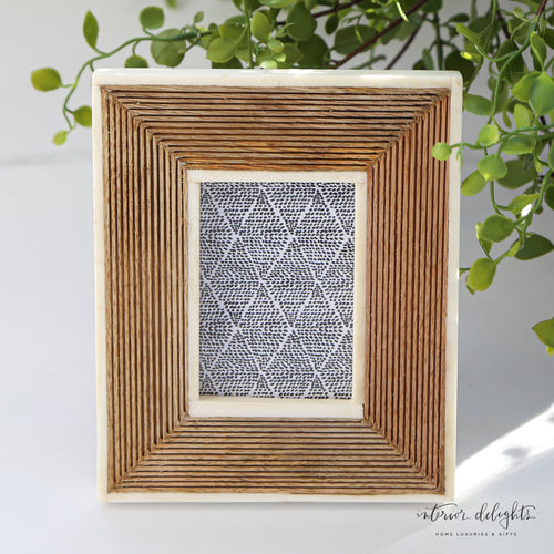 Hand-Carved Mini Photo Frame with Bone Border showcasing intricate lined detailing and smooth bone accents, perfect for holding a 2.75" x 3.75" photo.