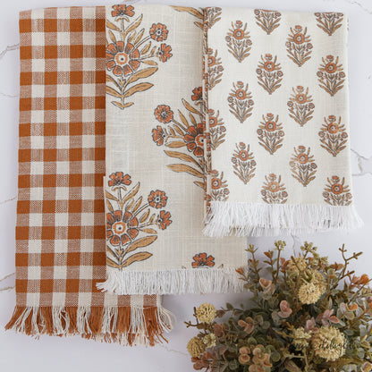 Autumn Block Print Tea Towels set of 3 featuring orange gingham, large floral block print, and small floral motif, adding a cozy touch to your kitchen.