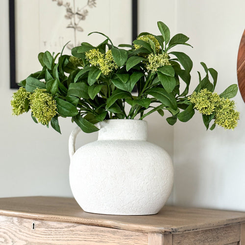 20" Green Leaf Spray & Jug Arrangement showcasing a beautiful terracotta vase with green leaf bloom sprays, perfect for seasonal decor.